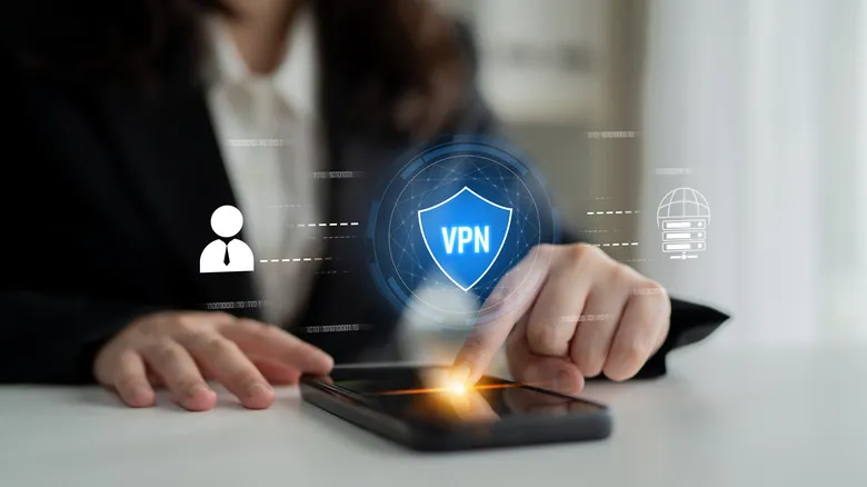 A person using a phone with a VPN logo floating over it