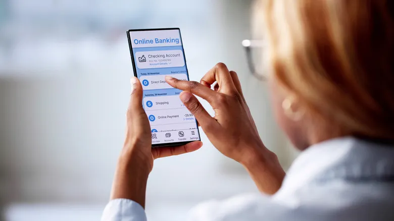 A person using an online banking app on their phone